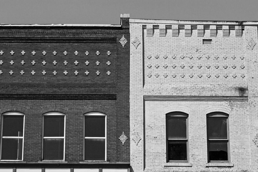 Black and white photograph of two adjoined historic buildings in beautiful downtown Florence, Alabama. With one constructed of red brick, and the other of yellow, they make an interesting contrast.