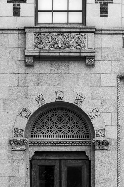 Black and white architectural detail photograph of the facade of 93 Patton Avenue in Asheville, North Carolina, featuring ornate decorative stone carvings.