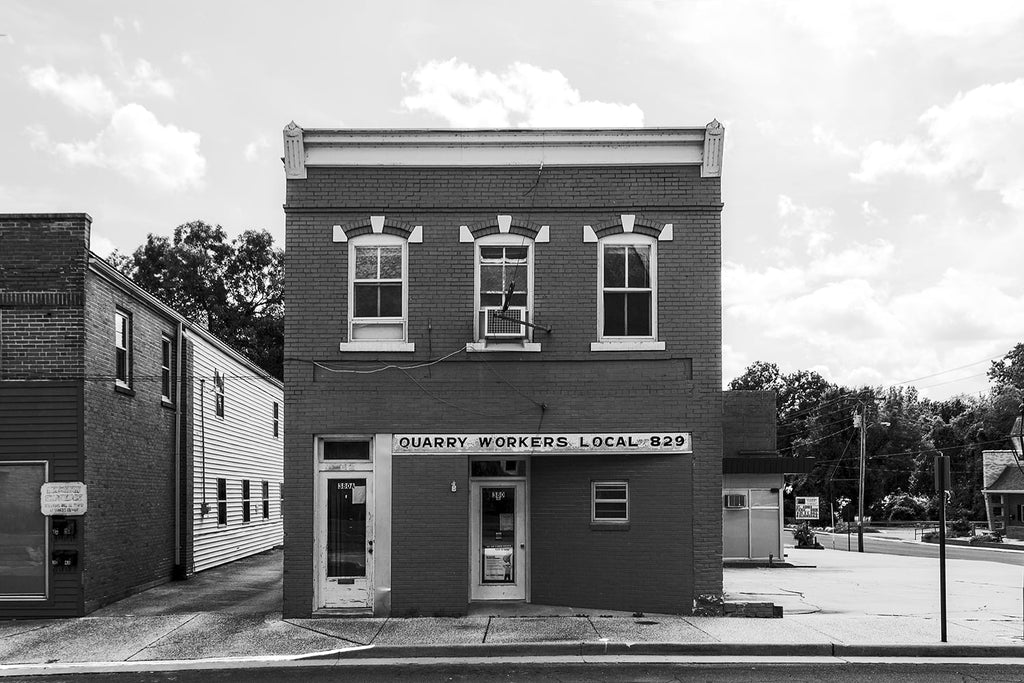 Black and white architectural photograph of the old brick building that houses Quarry Workers Local 829 in Ste Genevieve, Missouri.
