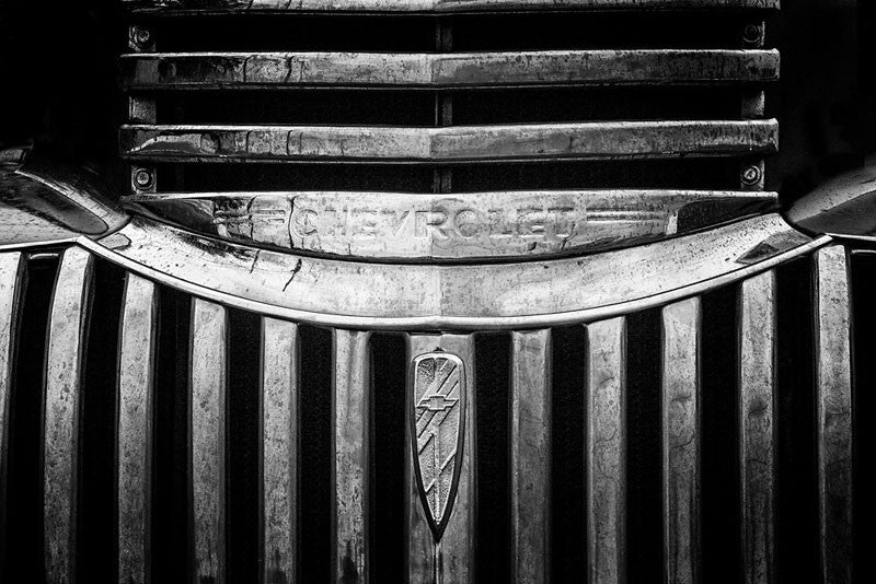 Black and white fine art photograph of the chrome grill of a 1947 Chevrolet.