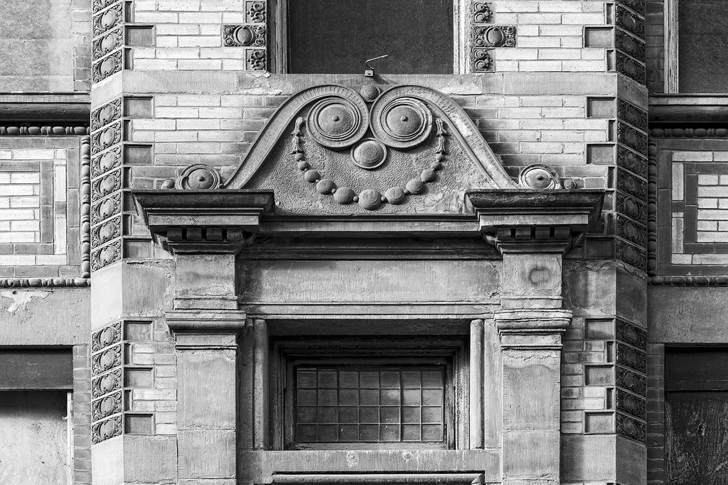 Black and white architectural detail photograph of an old building in Nashville built in the 1890s that seems to feature a quirky smile.