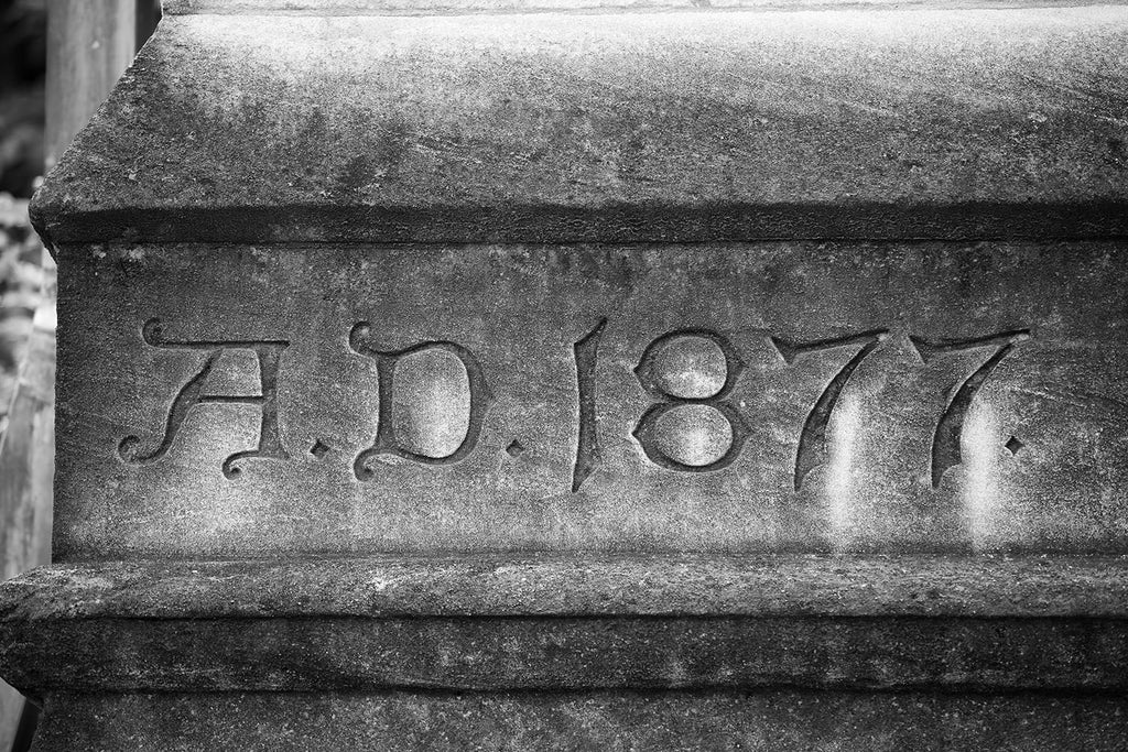 Black and white photograph of the weathered limestone corner stone of the historic Customs House in Nashville, displays the words "A. D. 1877."