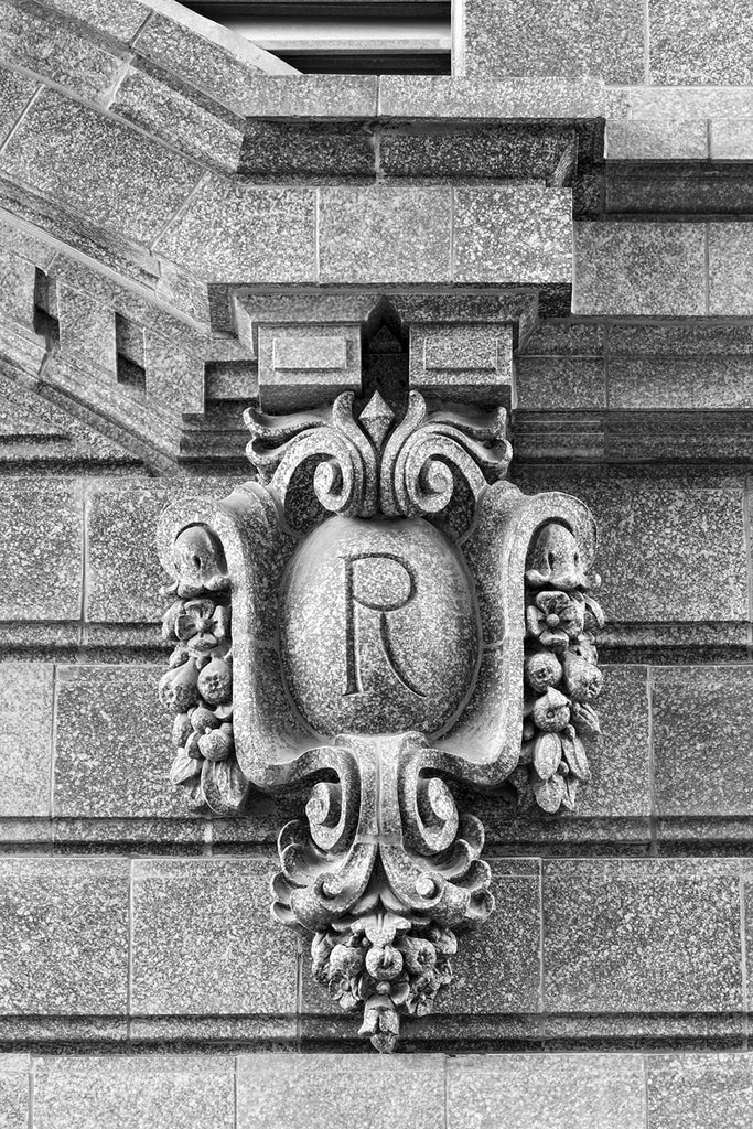 Black and white fine art photograph of an ornate architectural detail in downtown Kansas City featuring a capital R
