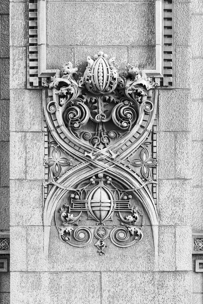 Black and white fine art photograph of an ornate "Sullivanesque" design seen at street level on the exterior of Kansas City's 1906 Scarritt Building. Ornate architectural elements like this were used to add beauty to the cold, new form of architecture known as skyscrapers, and are named after their most ardent creator, Chicago architect Louis Sullivan.