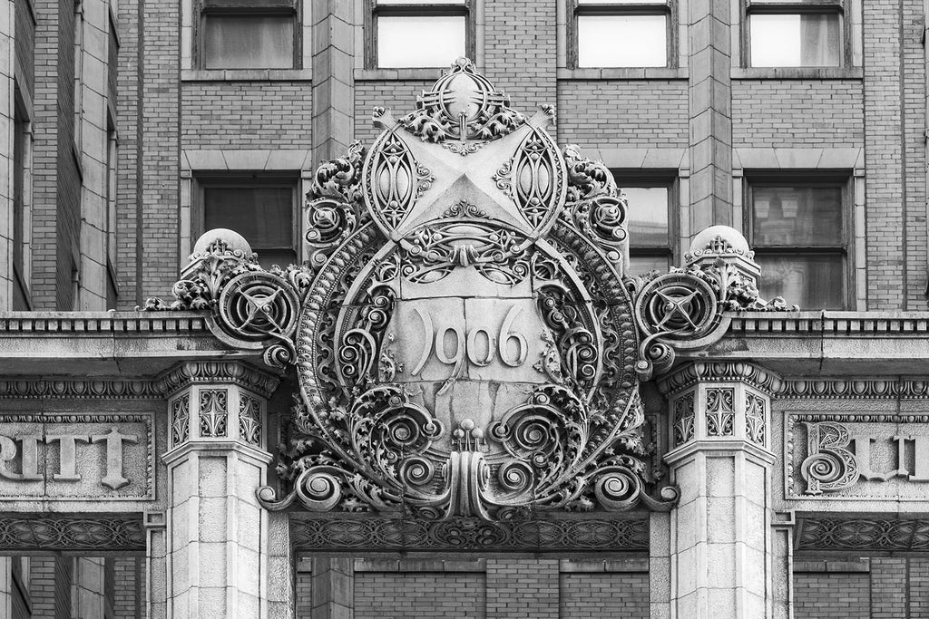 Black and white fine art photograph of the meticulously ornate Edwardian-style "1906" Sign on the exterior of downtown Kansas City's Scarritt Building.