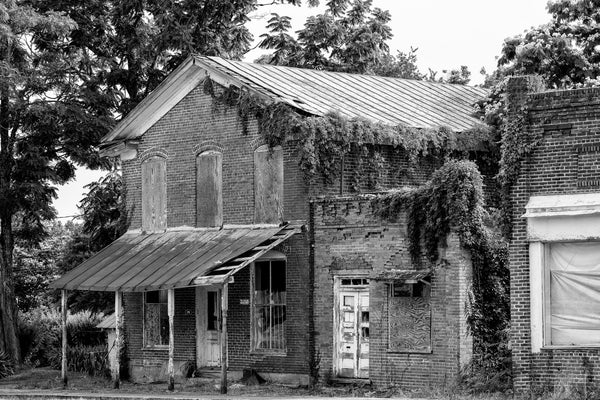 Black and white photograph of three buildings along the abandoned old Main Street in Pamplin City, Virginia.
