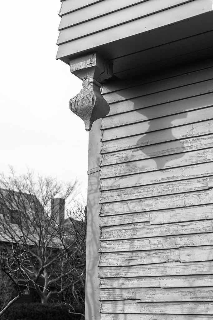Black and white architectural detail photograph of the woodwork on the 350-year-old Hawthorne house in Salem, Massachusetts known as the House of Seven Gables. 