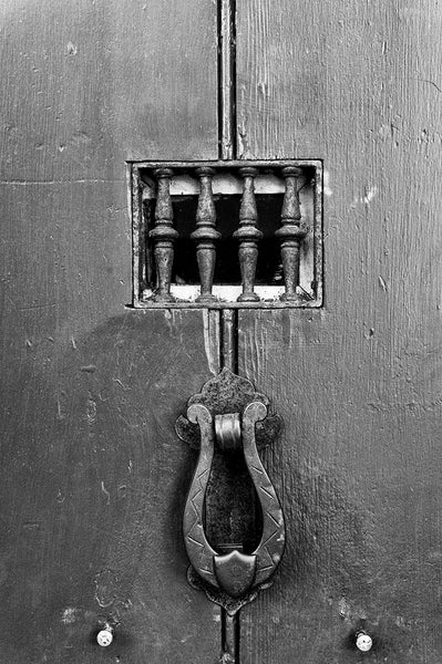 Black and white photograph of a door to a historic house in the old town of St. Augustine, Florida, the oldest continuously occupied European city in the US.