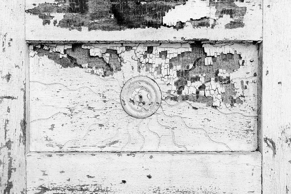 Black and white architectural detail photograph of a sunburst pattern on the antique wooden doors of the J.E. Winters and Co. Dry Goods building circa 1897 in the abandoned downtown of tiny Adams, Tennessee. Adams is famous as the home of the Bell witch legend.