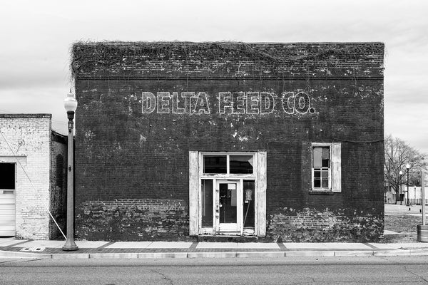 Black and white architectural photograph of the front façade of the old Delta Feed Company in Greenwood, Mississippi.