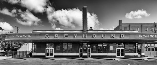 Black and white panoramic photograph of a historic small-town Greyhound bus station that operated from 1938 until 2018.