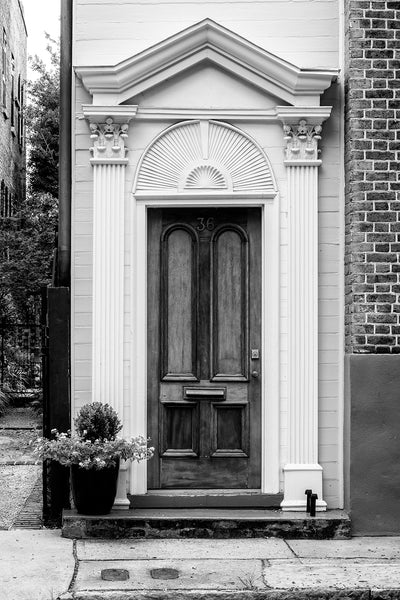 Black and white photograph of a historic street-level door in Charleston. Unlike most place, these doors open to a large back porch rather than to the interior of the home.