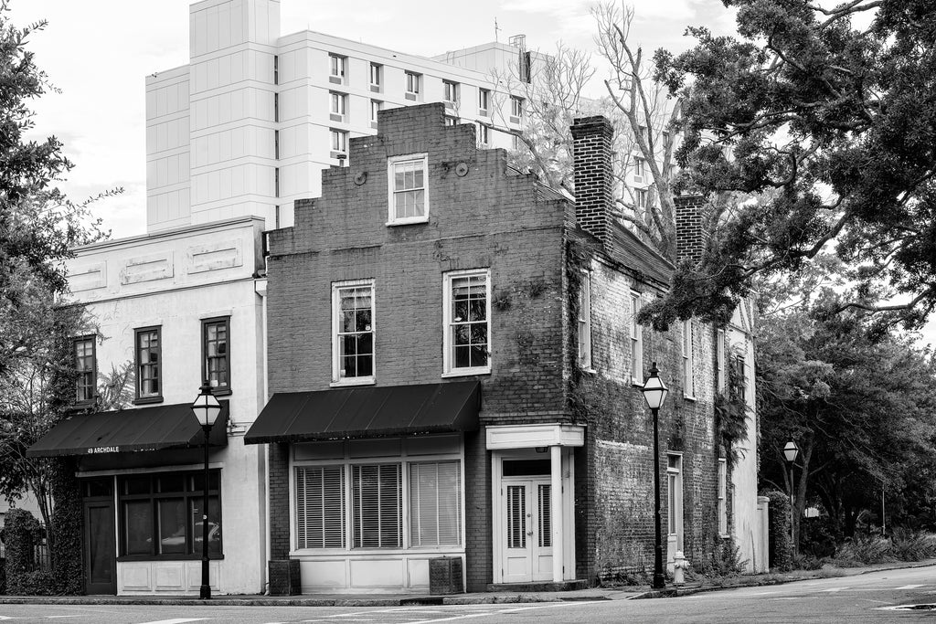 Black and white photograph of old and new architecture as seen from the traffic curve at Archdale and Beaufain Streets in Charleston.