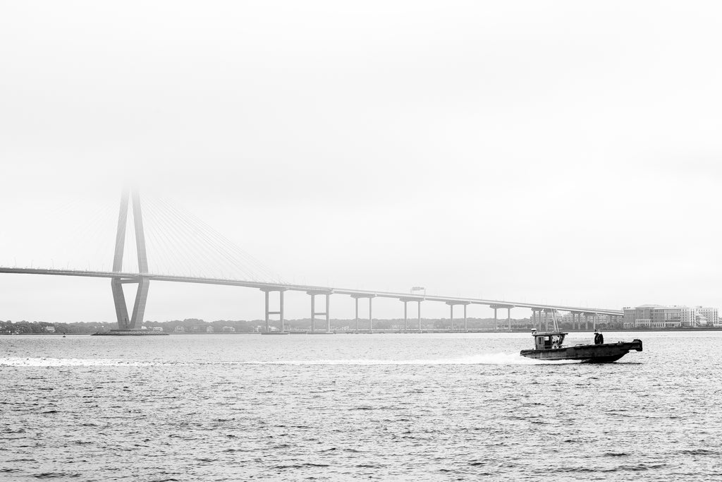 Black and white photograph of Charleston's iconic Ravenel Bridge over the Cooper River seen on a foggy morning.