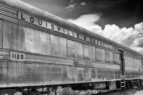 Black and white photograph of an old Louisville and Nashville railroad car sitting on tracks.
