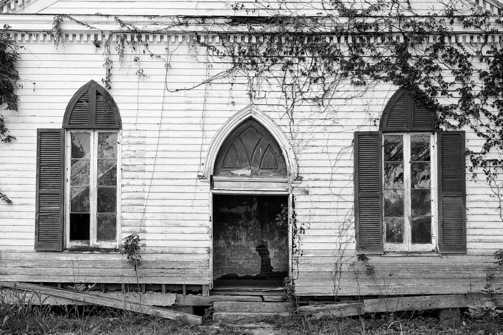 Black and white photograph of the front of a ruined, abandoned 1850s Baptist church in the town of Rodney, Mississippi -- a ghost town established along the Mississippi River in the 1820s.