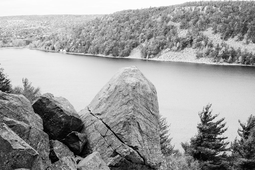 Black and white landscape photograph of Devil's Lake, Wisconsin as seen from the bluffs above.