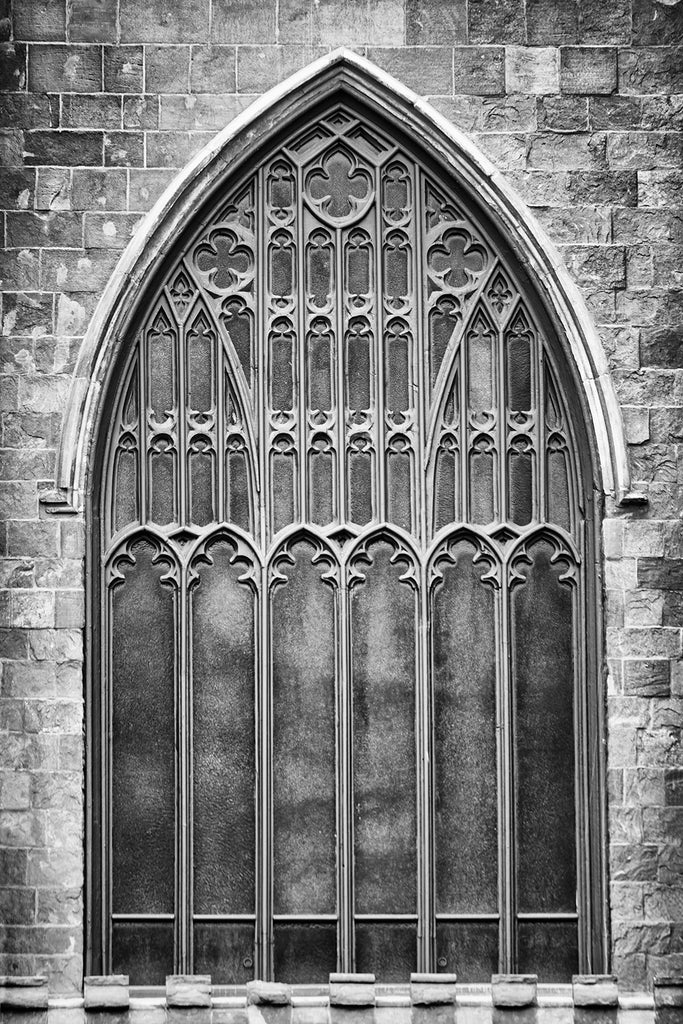 Black and white photograph of a historic gothic-style church window in Salem, Massachusetts, now used as a museum.