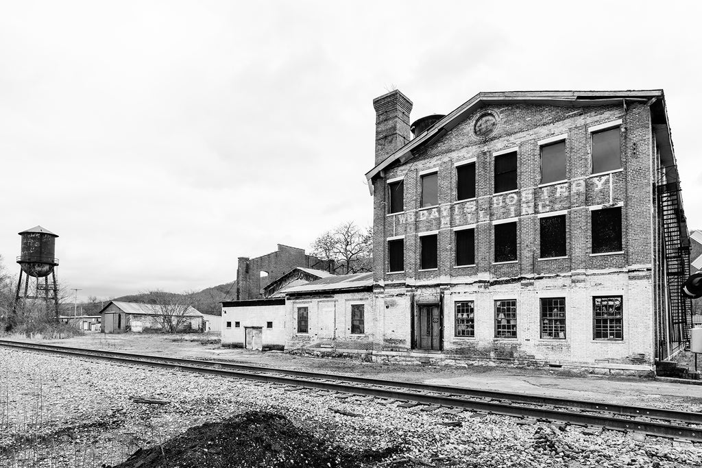 Black and white photograph of the old W. B. Davis Hosiery Mill in Ft. Payne, Alabama. The mill was built in 1884 to make hardware and tools, but closed after their supply of iron ore and minerals fell short. It was reopened in 1909 as a hosiery mill making socks.