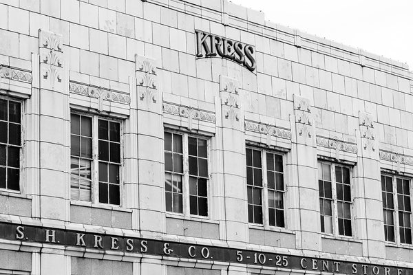 Black and white photograph of the old Kress Department Store in downtown Anniston, Alabama. This provides a great look at the dimensional gold letters on the front of the store. At the time it was photographed, the space was totally vacant.