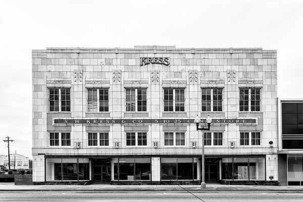 Black and white photograph of the façade of the old Kress Department Store in downtown Anniston, Alabama. At the time it was photographed, the space was totally vacant.