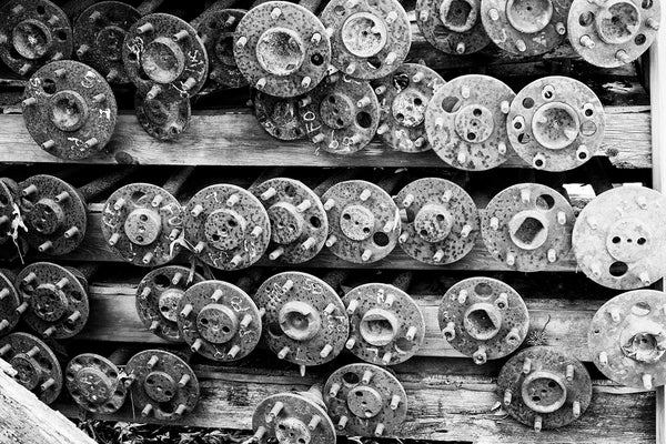 Black and White Photograph of 39 Rusty Antique Car Axles