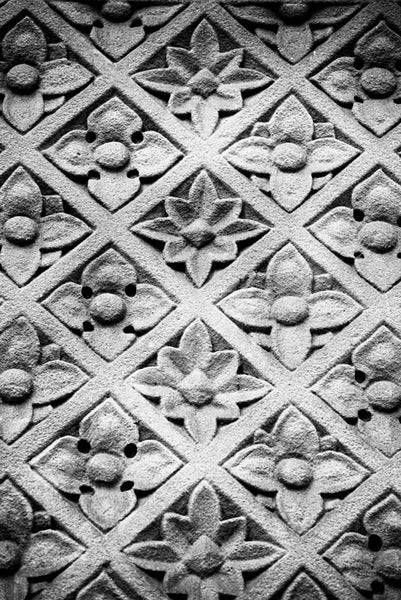 Black and white architectural abstract photograph of carved floral sandstone wall pattern on a historic building in Memphis, Tennessee.