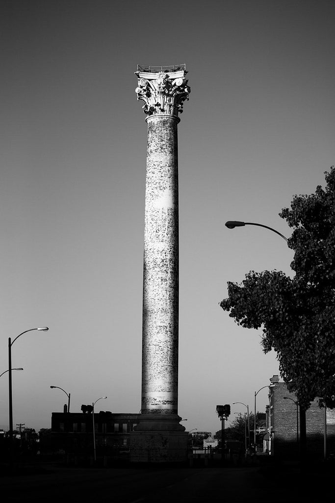 Black and white photograph of the historic Grand Avenue Water Tower, located on Grand Avenue at 20th Street in the College Hill neighborhood of St. Louis. Built in 1871 by George Barnett, the brick and iron tower was designed in the style of a Corinthian column, and is the oldest water tower in St. Louis. 