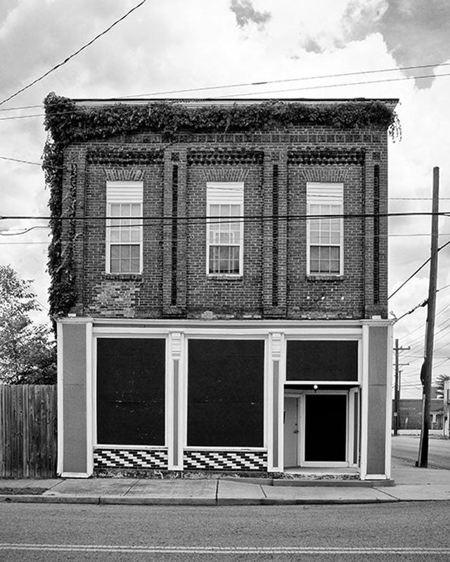 Black and white photograph of the front of an old pharmacy building in the Chestnut Hill neighborhood of Nashville.