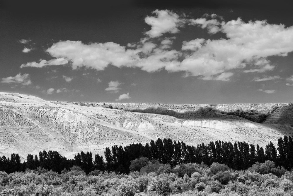 Black and white photograph of the Idaho landscape with cloud shadows passing over the terrain.