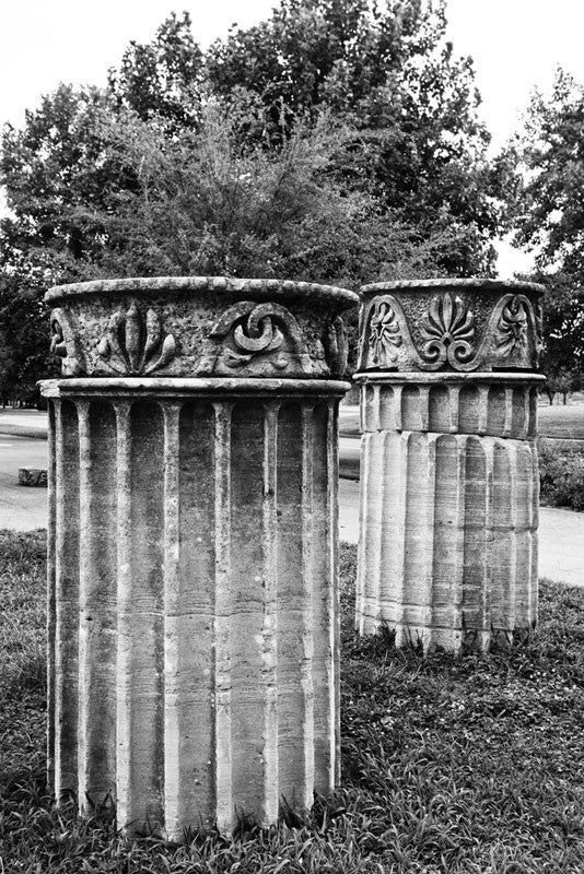 Black and white photograph of two standing Greek Revival columns in Nashville. Originally part of the Tennessee State Capitol building, these columns were removed during a renovation and have been scattered around Nashville as a reminder of its reputation as "the Athens of the South."
