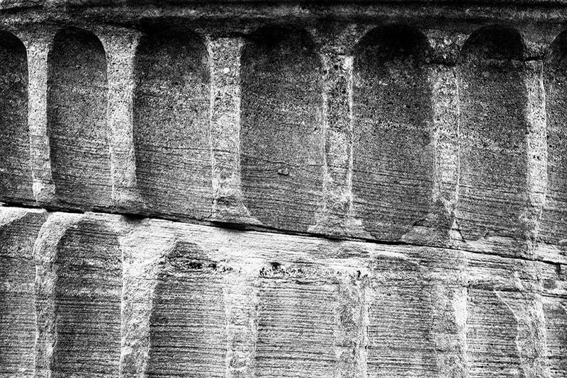 Black and white detail photograph of a Greek Revival column fragment from the original Tennessee State Capitol building in Nashville, Tennessee. These pieces of stone columns have been scattered around Nashville as a reminder of its reputation as "the Athens of the South."