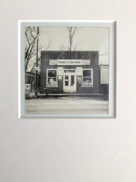 Original one-of-a-kind black and white Polaroid photograph of an abandoned country store called Pearcy's General Merchandise. Archivally mounted and overmatted with white 4-ply mat. Ready to fit an 11″ x 14″ frame.