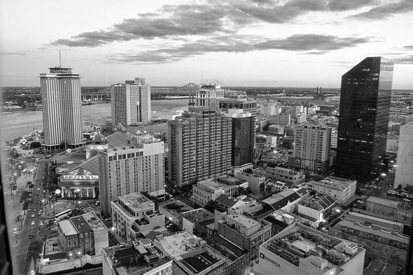 Black and white photograph aerial view of New Orleans business district, Canal Street and the Mississippi River.