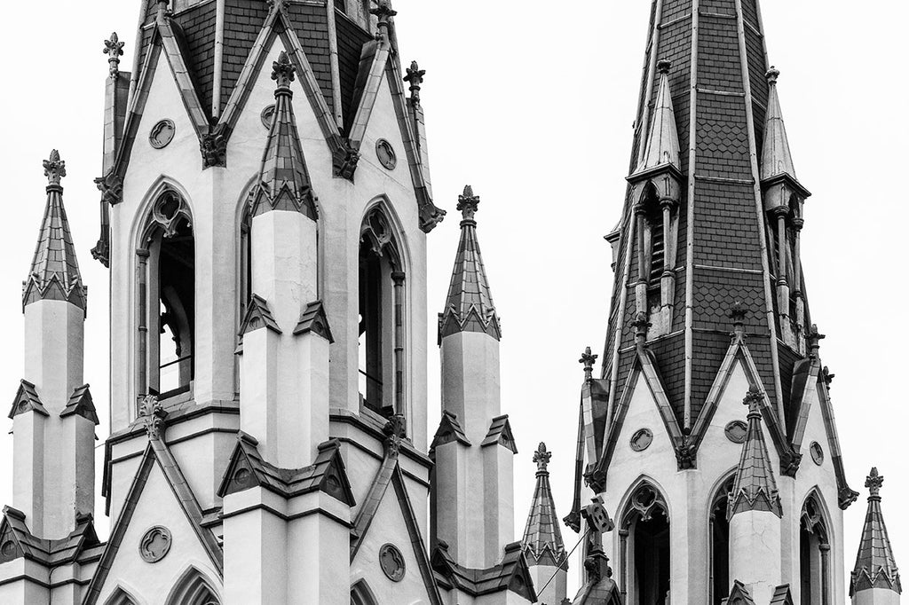 Black and white architectural photograph of the beautiful spires of The Cathedral of St. John the Baptist, in downtown Savannah. The cathedral in its current incarnation was completed in 1896, but was partially destroyed by fire in 1898, and subsequently rebuilt in 1899.
