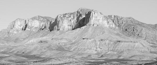 Vast black and white panoramic landscape photograph of West Texas mountains in the bright light of the desert sun.