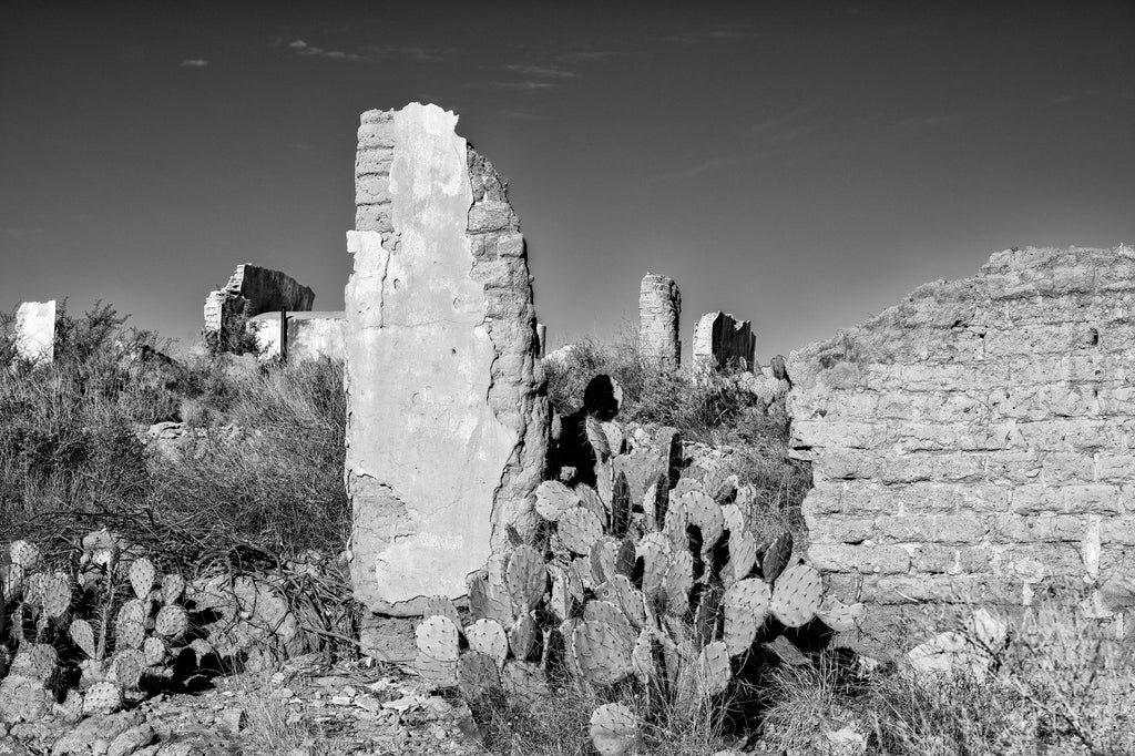 Black and white photograph of the stone ruins of an old mine in the desert at the Shafter ghost town, near the Mexican border in Texas. 
