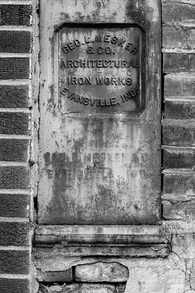 Black and white photograph of an old sign for George L Mesker and Co. Architectural Iron Works found on a building in a small midwestern town.