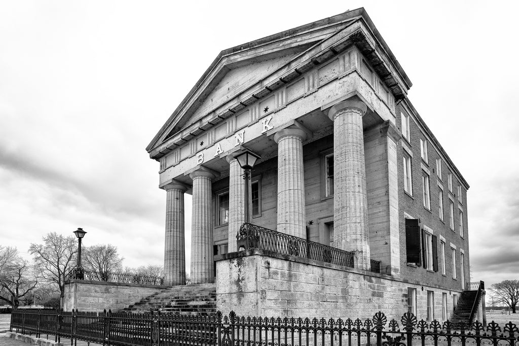Black and white photograph of the big historic abandoned bank in Old Shawneetown, Illinois. Built between 1839 -1841, it's the oldest bank building in the state, and legend says the bank once declined to buy the first bonds issued by the city of Chicago, thinking the city had no future.