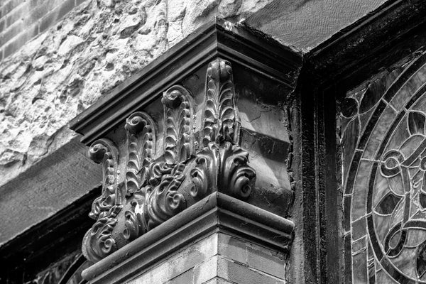 Black and white photograph of a brick pilaster with a Corinthian capital on the front of the Third Presbyterian Church, built 1887 in South Wheeling, West Virginia.