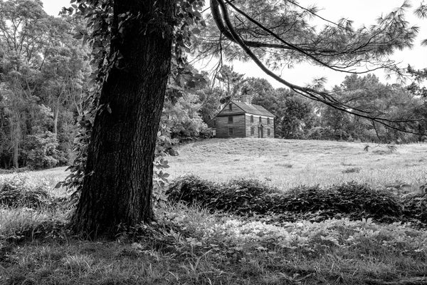 Black and white photograph of the verdant New England landscape with a view of the historic house of Captain William Smith, built in 1692 on the old Lexington and Concord Road in Massachusetts.