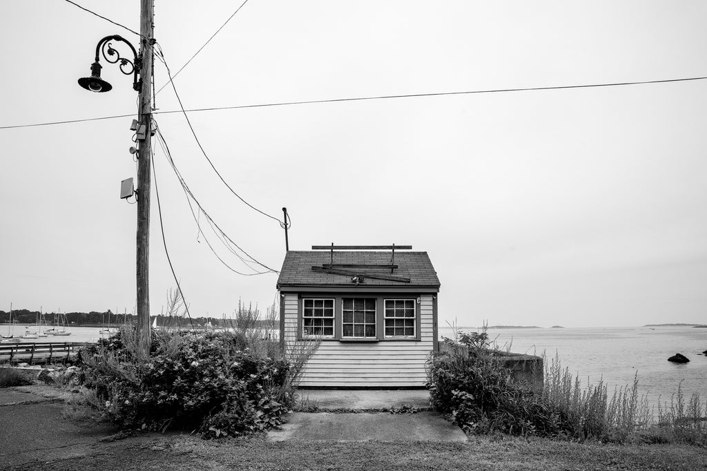 Black and white photograph of a vacant little snack shack on the beautiful Atlantic coast of Massachusetts
