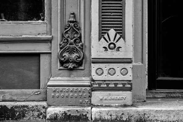 Black and white photograph of beautifully maintained architectural ironwork by W.H. Cheney on old buildings in downtown Rochester, New York.