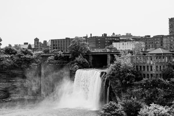 Black and white photograph of the huge waterfall called High Falls in the midst of downtown Rochester, New York.