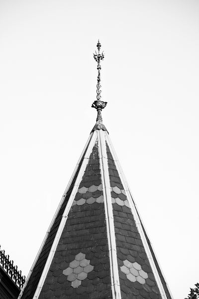 Black and white photograph of a decorative lightning rod atop the spire of a historic Victorian-style house in Danville, Virginia.