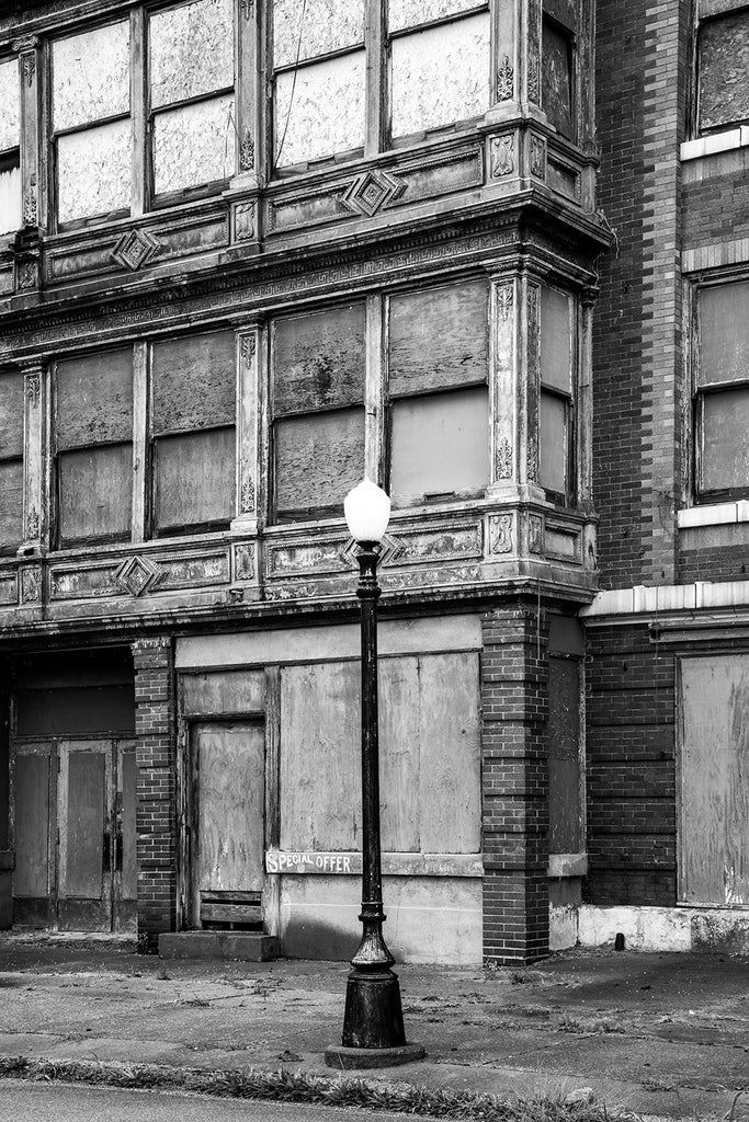 Black and white photograph of abandoned historic storefronts on deserted 7th Street in Cairo, Illinois.