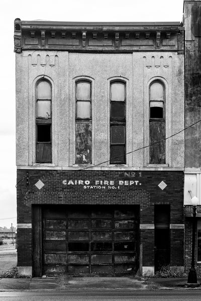 Black and white photograph of the front of the abandoned historic downtown fire station in Cairo, the southernmost city in the state of Illinois.