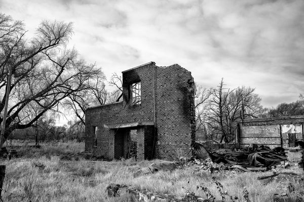 Black and white photograph of the burned ruins of an abandoned school built by the WPA in the 1930s in rural Oklahoma.