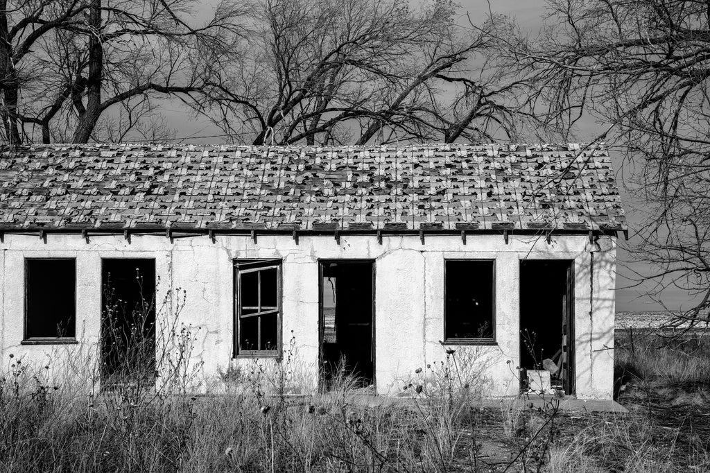 Black and white photograph of the abandoned ruins of the State Line Motel on a lonely stretch of old Route 66.