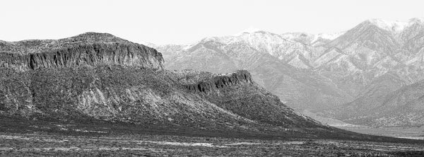 Black and white panoramic landscape photograph of the Godfrey Hills and Sacramento Mountains in New Mexico.